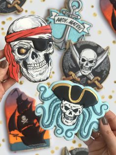 someone is holding up some pirate themed cookies