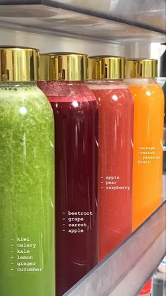 the bottles are labeled with different types of juices in them and on display for sale