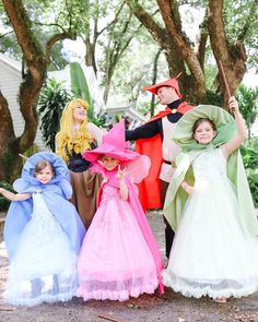 several children dressed up in costumes posing for the camera