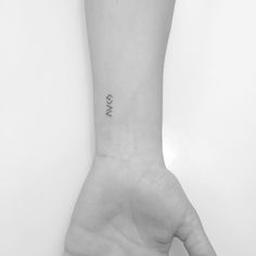 a person's arm with a small wrist tattoo on the left side of their hand