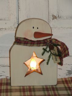 a wooden snowman with a star on it