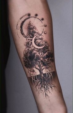 a tree and moon tattoo on the arm