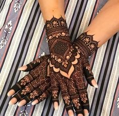 a woman's hands with hennap on top of her arm and hand