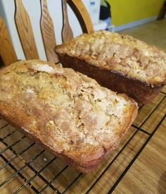 two loaves of bread cooling on a rack