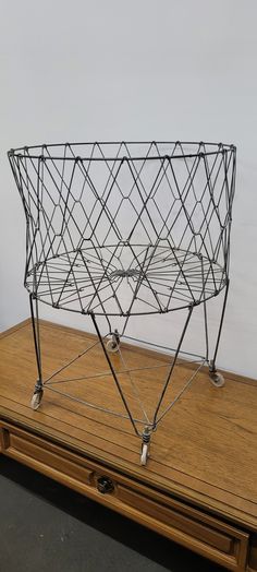 a wire basket sitting on top of a wooden table