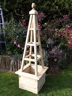 a small wooden tower sitting in the grass