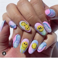 a woman's nails with smiley faces painted on the top and bottom half of them