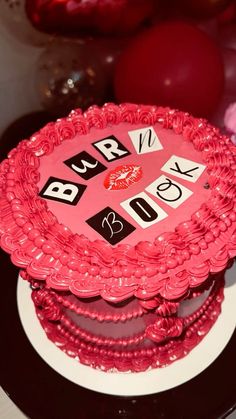 there is a pink cake with numbers on it