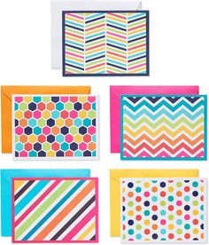 four colorful greeting cards with different patterns and designs on the front, one in bright colors