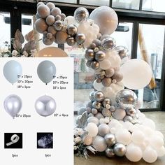 the balloon tree is decorated with silver and white balloons