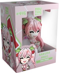 a pink doll in a box with an anime character on it's back side