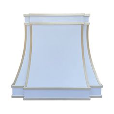 a white stove hood with gold trimmings on the top and bottom, against a white background