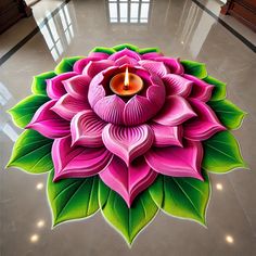 a pink flower with green leaves and a lit candle in the center on a floor