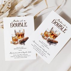 two business cards with whiskey and cigars on them