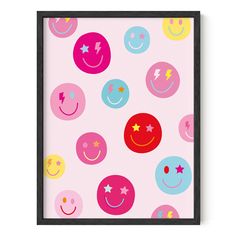 a pink background with smiley faces and stars on it, framed in black wood frame