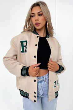 She'll be your absolute fave this winter! The Varsity Jacket offers a thick cozy material, a snap button down front, contrasting beige sleeves, a stitched on TSF logo and two front pockets. Style her with winter with Black flares, a cute top and chunky sneaks. FABRICATION: 60% polyester / 40% Polyester SIZING: Olivia's height is 163cm / 5'3 and wears a size AU XS/S Beige Varsity Jacket Outfit, Beige Varsity Jacket, Black Flares, Tops Bonitos, Crop Outerwear, Orange Swimwear, Green Swimwear, Summer Formal Dresses, Lounge Sweater