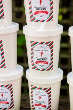 several ice cream cups stacked on top of each other with red, white and green designs