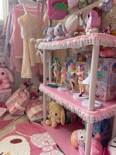 a room filled with lots of toys and stuffed animals on top of pink shelving