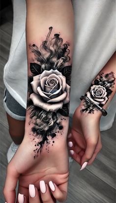 two women holding hands with black and white tattoos on their arms, one has a rose