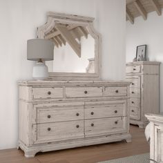 a white dresser and mirror in a room