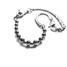 Power up your look with this daring grunge necklace. Hand strung stainless steel beads and cable chain provide texture and depth. An adjustable swivel clasp closure ensures you get the perfect fit. Take risks with your fashion and make a bold statement with this Komet necklace. 21 inches full length, adjustable down to 14 inches stainless steel stone spacers adjustable swivel clasp Modern Silver Chain Bracelet For Streetwear, Modern Metal Chain Necklace With Silver Chain, Silver Stainless Steel Necklace For Streetwear, Modern Silver Chain Metal Necklace, Metal Chain Necklace For Everyday Use, Modern Link Jewelry For Streetwear, Edgy Silver Jewelry For Everyday, Edgy Metal Necklace For Everyday Wear, Minimalist Metal Jewelry For Streetwear