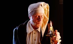 an old man with a candle in his hand