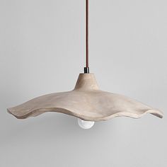 a light fixture hanging from a ceiling in the shape of an umbrella with a wooden handle