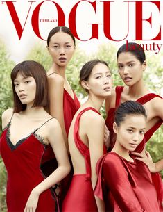 four models in red dresses on the cover of a magazine