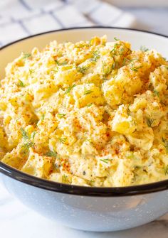 a bowl filled with potato salad on top of a table