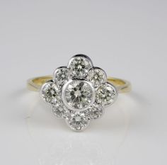 an engagement ring with three stones in the center and two diamonds at the bottom, on a white background