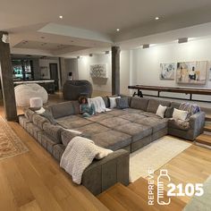 a living room filled with furniture and lots of wood flooring on top of a hard wood floor