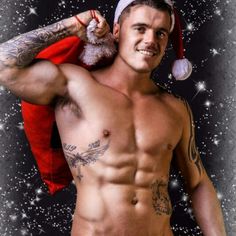 a man with a santa hat on his head and no shirt is posing for the camera