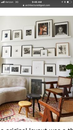 a living room filled with furniture and framed pictures on the wall above it is an article about