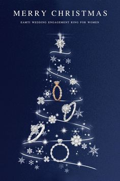 a christmas tree with rings on it and snowflakes all over the top, in front of a dark blue background