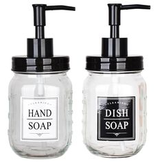 two glass soap dispensers with black lids on each one and the other hand soap