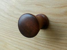 a wooden door knob on a wood surface