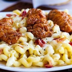 there is pasta with meatballs and macaroni on the plate next to it