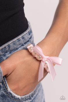 Delicately wrapped in the folds of a baby pink ribbon, gleaming white pearls are infused along an elastic stretchy band around the wrist for a feminine, girly statement.

Sold as one individual bracelet. Pink And White Bracelet, Ballet Stuff, Pink Pearl Bracelet, Ribbon Bracelet, Ribbon Bracelets, Lanyard Necklace, Baby Black, Pearl Bracelets, Wooden Bracelet