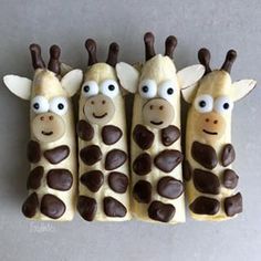 three giraffes made out of cookies with chocolate eyes and noses on them