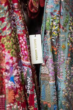 a close up of a colorful shirt with a tag hanging from it's back