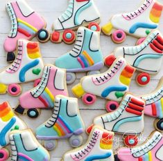 decorated cookies with roller skates and rainbow icing on a white wooden table top