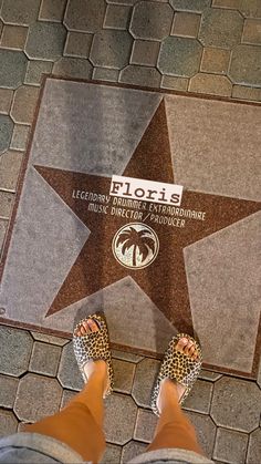 a person standing in front of a star on the walk of fame