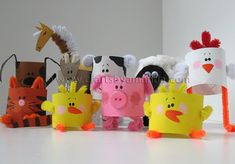 a group of paper animals standing next to each other on top of a white table