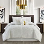 a bedroom with white bedding and gold chandelier