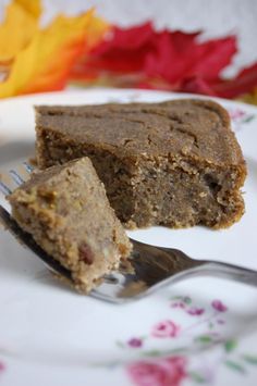 a piece of cake sitting on top of a white plate with a fork next to it