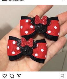 two red and black minnie mouse hair bows with white polka dots on each bow, one being held in the palm of someone's hand