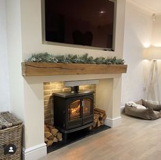 a living room with a fireplace and television mounted on the wall