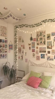 a bedroom decorated with lights and pictures on the wall