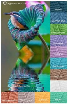 a bird sitting on top of a green leaf next to water with colors in the background