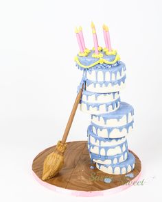 a blue and white cake with candles on top